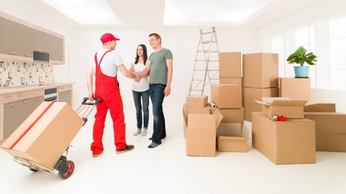 Professional team handling desks and office equipment during a Paddington move